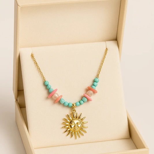 Necklace with sun pendant and colorful beads in a beige jewelry box
