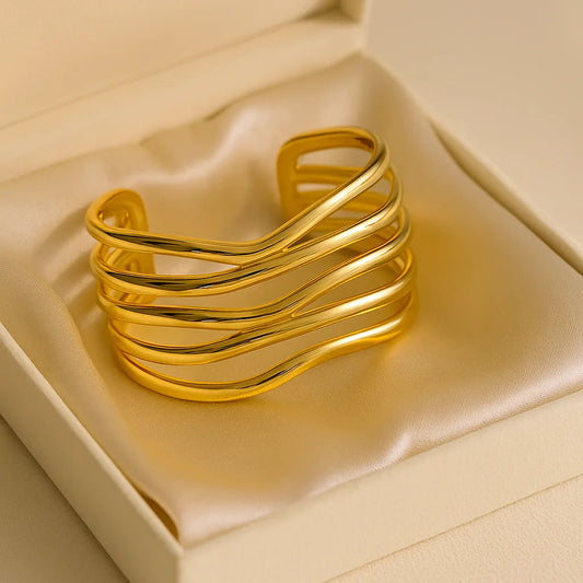 Gold bracelet in a box on a beige background