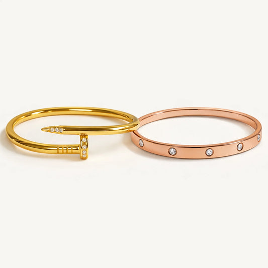 Two gold and rose gold bangles with small diamonds on a white background