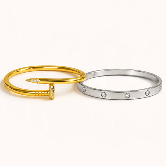 Gold and silver bangles with small stones on a white background