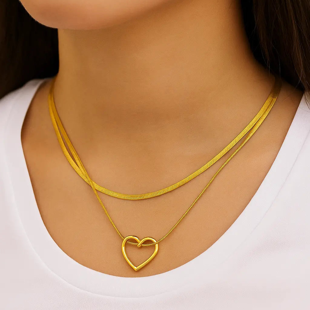 Gold necklaces with a heart pendant on a white background