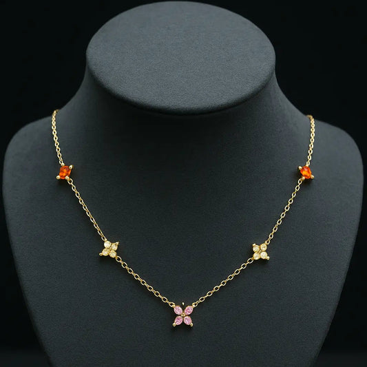 Gold necklace with butterfly pendants on a black mannequin bust