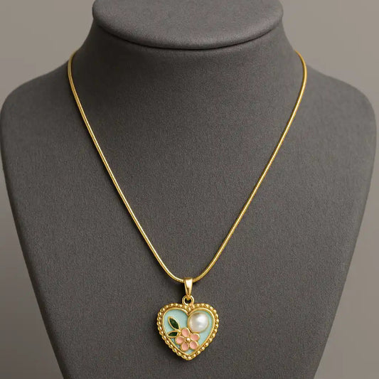 Heart-shaped pendant necklace on a gray mannequin bust