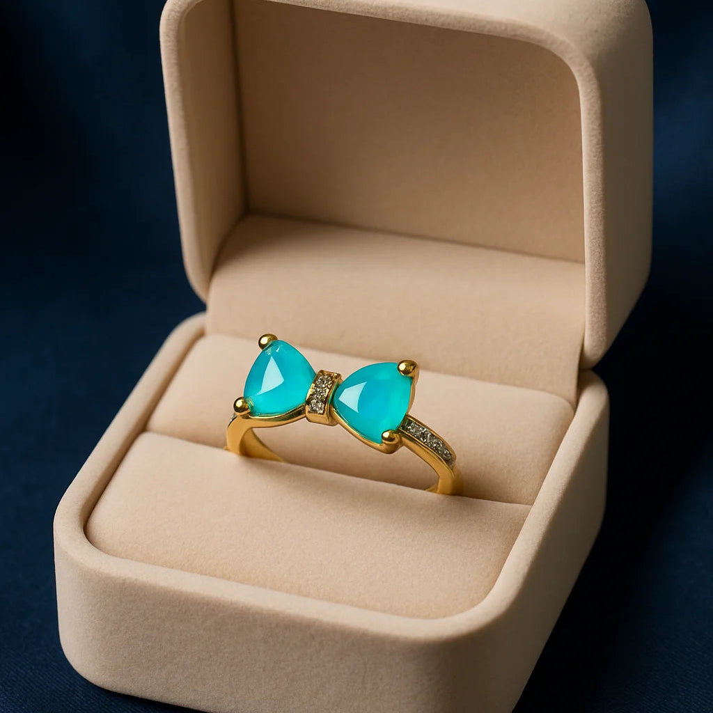 Turquoise gemstone ring in a beige jewelry box on a dark background