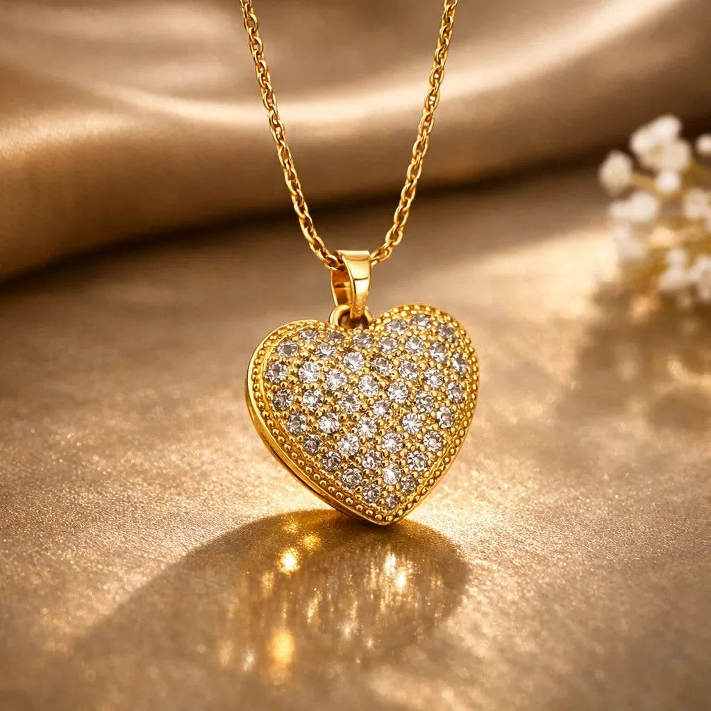 Gold heart-shaped pendant with diamonds on a gold chain against a gold background