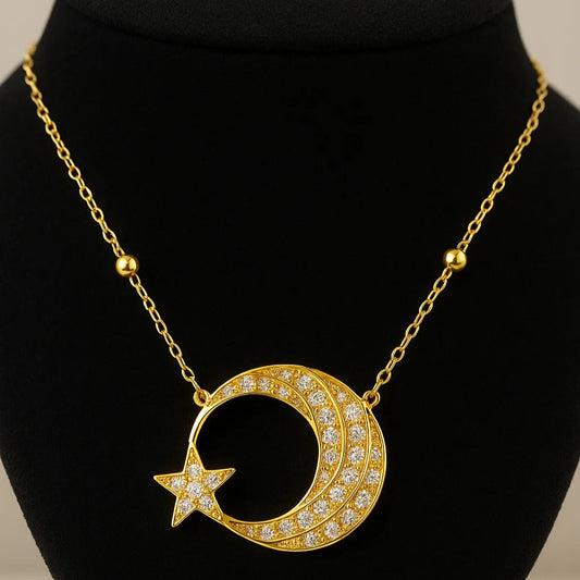 Gold necklace with crescent moon and star pendant on a black bust