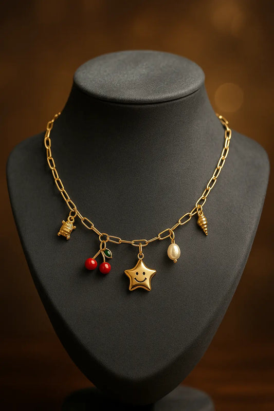 Gold necklace with charms on a black mannequin bust against a dark background