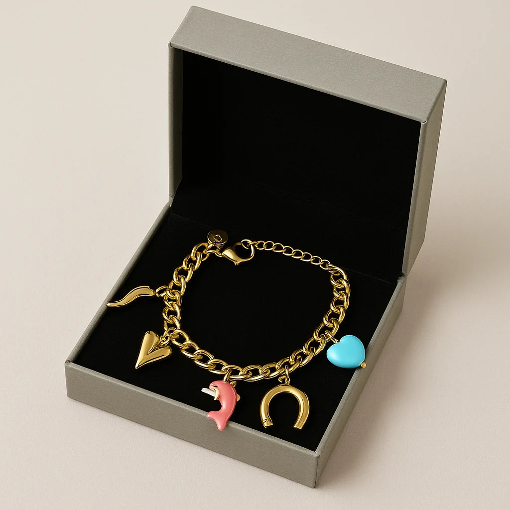 Gold bracelet with charms in a gray box on a beige background