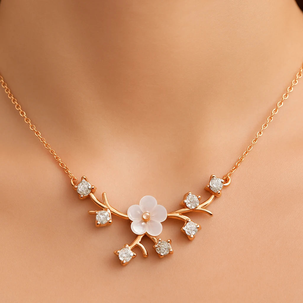 Gold necklace with floral design on a person's neck
