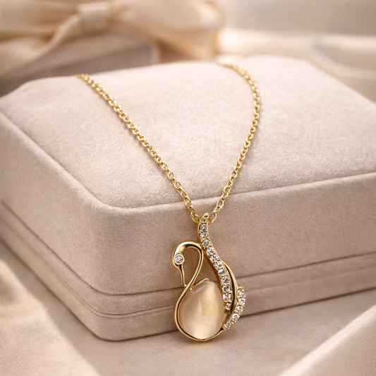 Gold necklace with a pendant on a beige fabric background