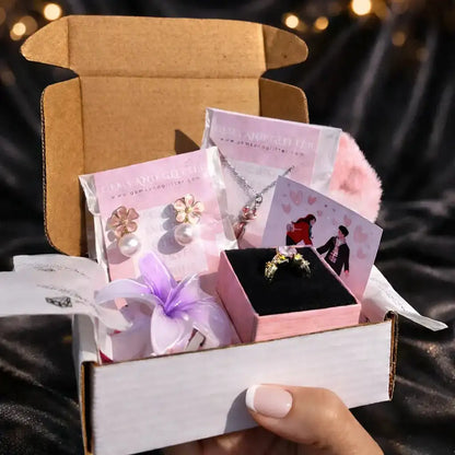 Open jewelry box with a ring and cards on a dark fabric background