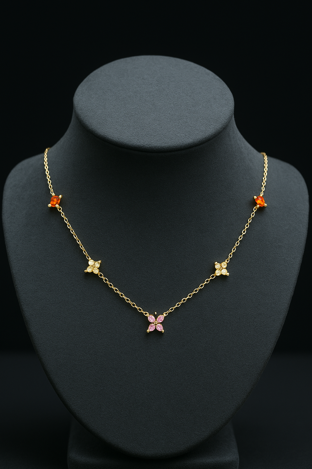 Gold necklace with butterfly pendants on a black mannequin bust