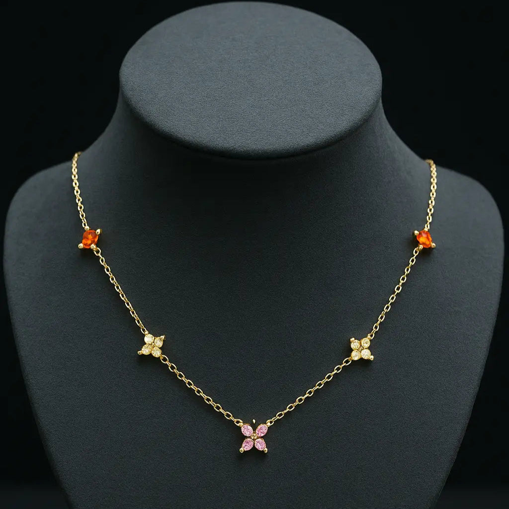 Gold necklace with butterfly pendants on a black mannequin bust