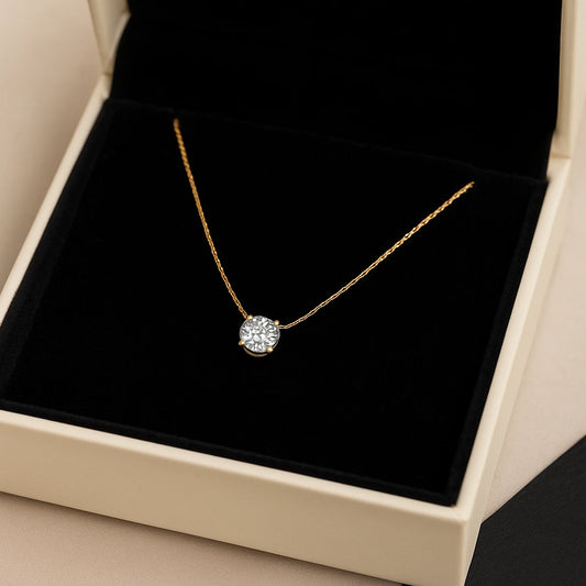 Gold necklace with a diamond pendant in a black jewelry box