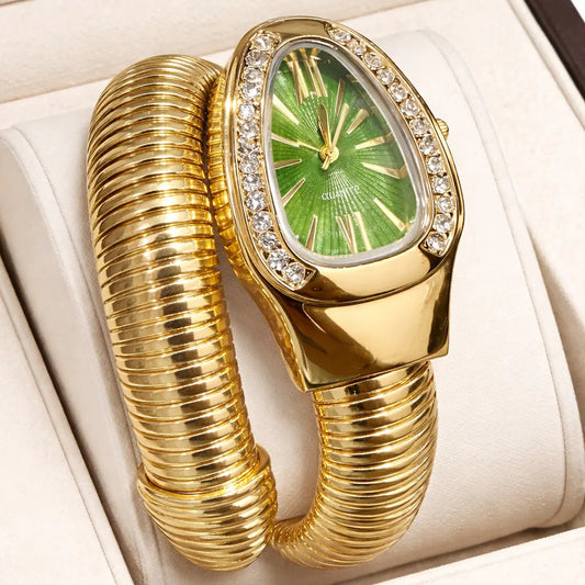 Gold bracelet with green gemstone watch face in a box