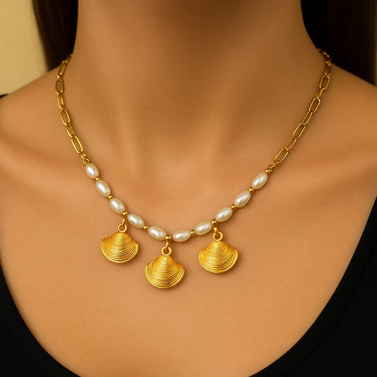 Gold necklace with shell pendants on a model
