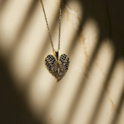 Heart-shaped pendant necklace with intricate design on a marble surface