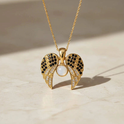 Gold necklace with a detailed pendant on a beige background