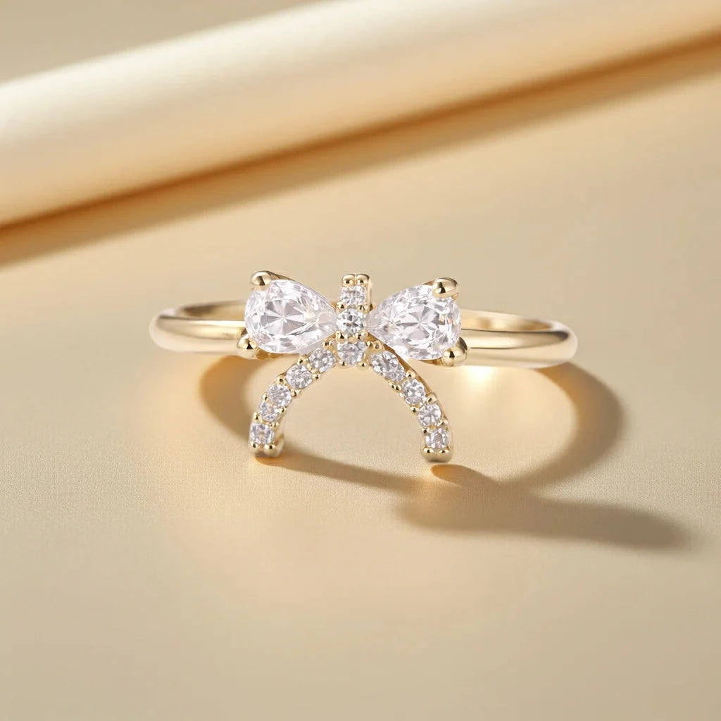 Gold ring with diamond accents on a beige background