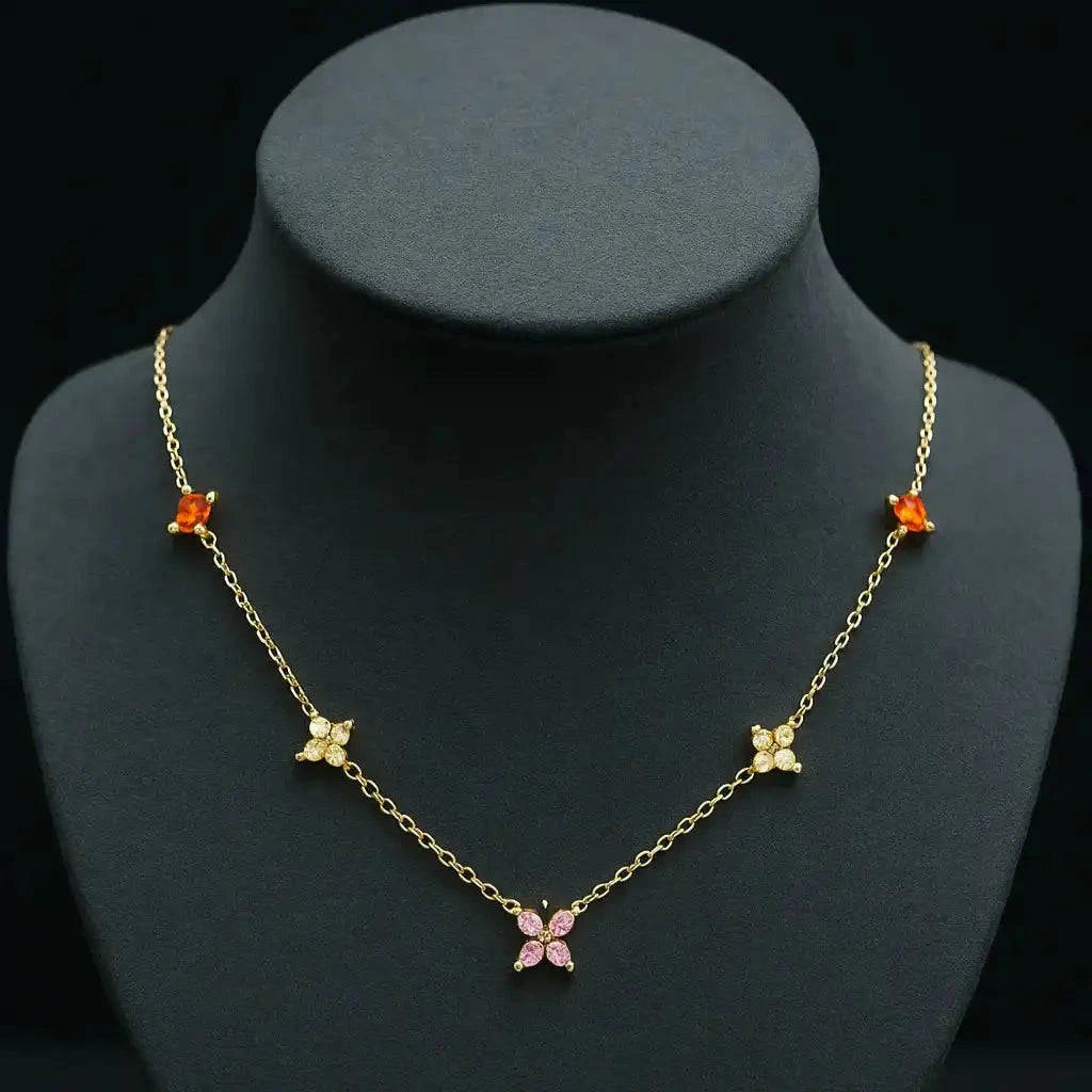 Gold necklace with butterfly pendants on a black mannequin bust