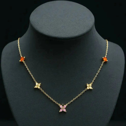 Gold necklace with butterfly pendants on a black mannequin bust