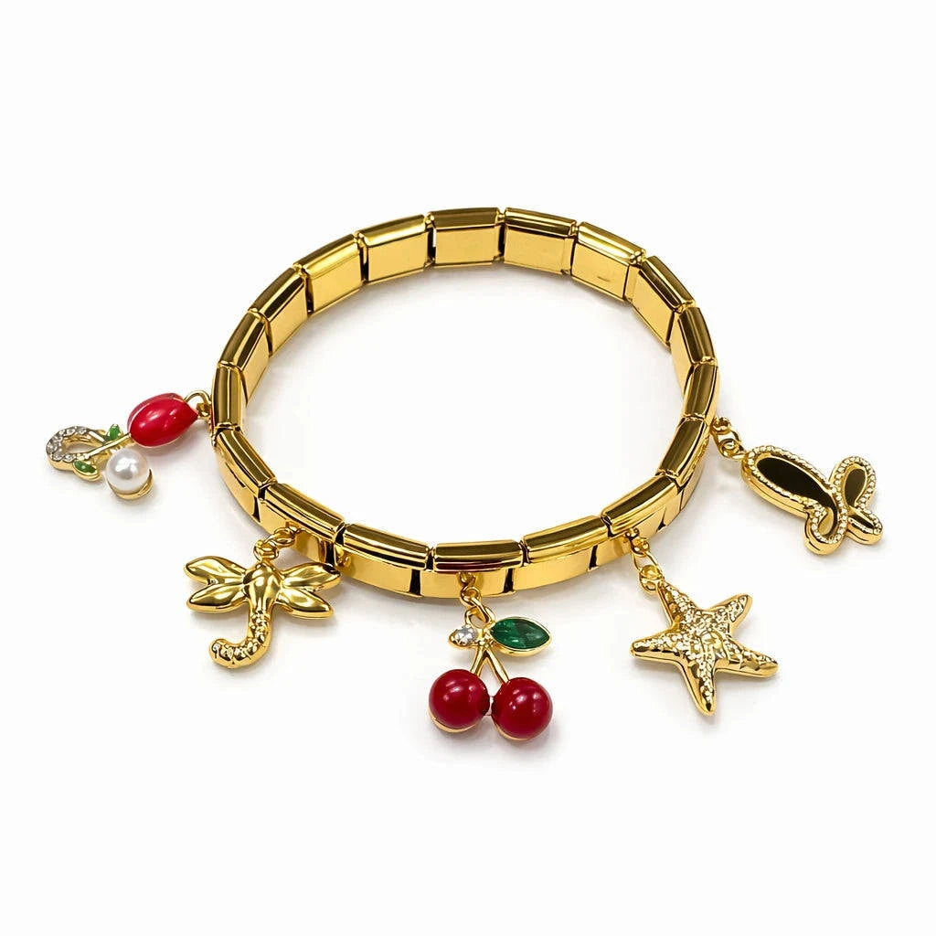 Gold bracelet with various charms on a white background