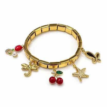 Gold bracelet with various charms on a white background