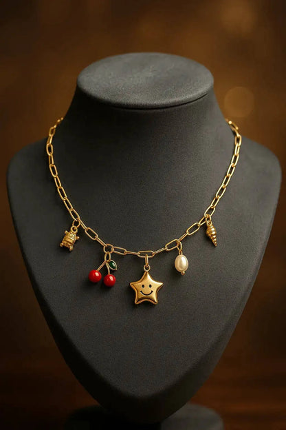 Gold necklace with charms on a black mannequin bust against a dark background
