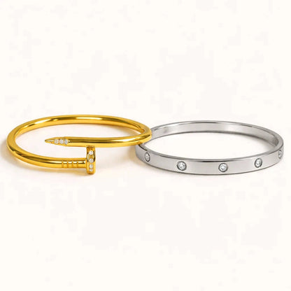 Gold and silver bangles with small stones on a white background