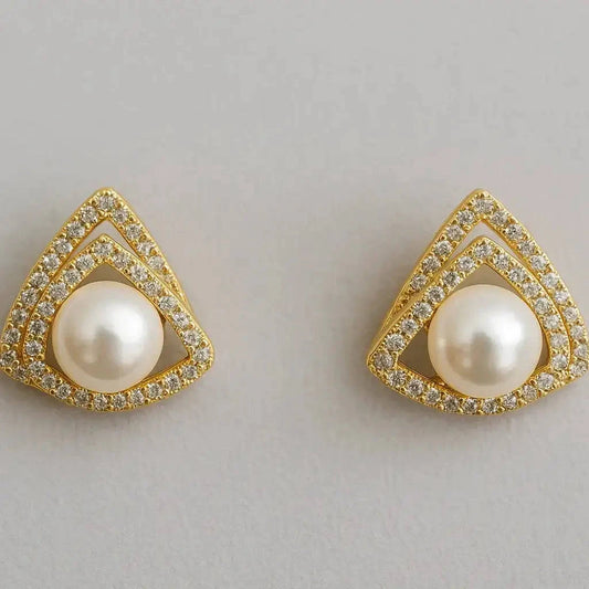 Pair of gold-trimmed pearl earrings on a light gray background