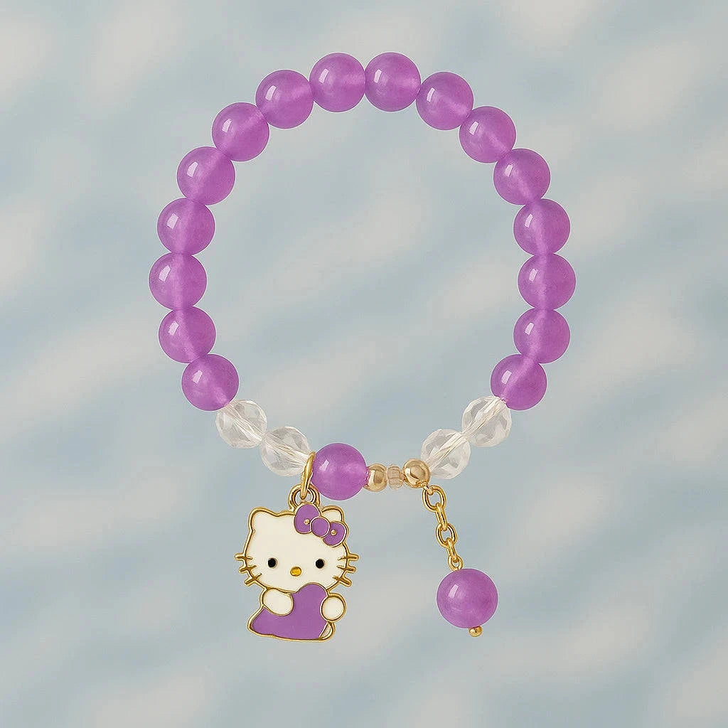 Purple beaded bracelet with a Hello Kitty charm on a blurred background