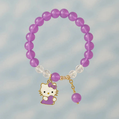 Purple beaded bracelet with a Hello Kitty charm on a blurred background