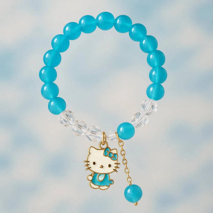 Turquoise beaded bracelet with a Hello Kitty charm on a blurred background