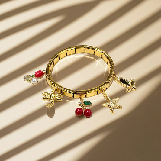 Gold bracelet with various charms on a beige background