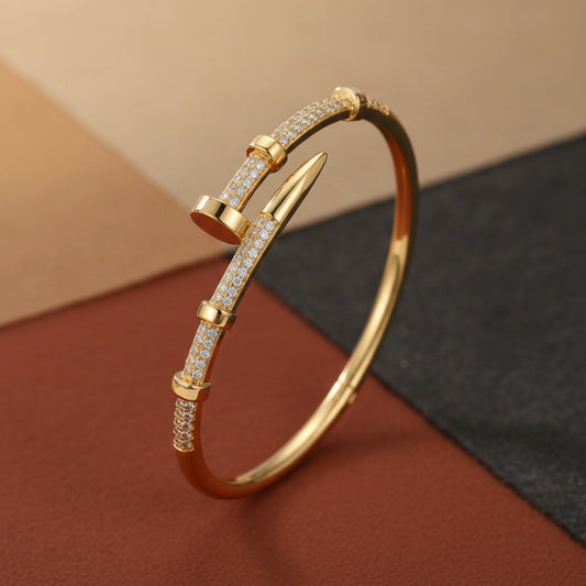 Gold bracelet with diamond accents on a textured surface