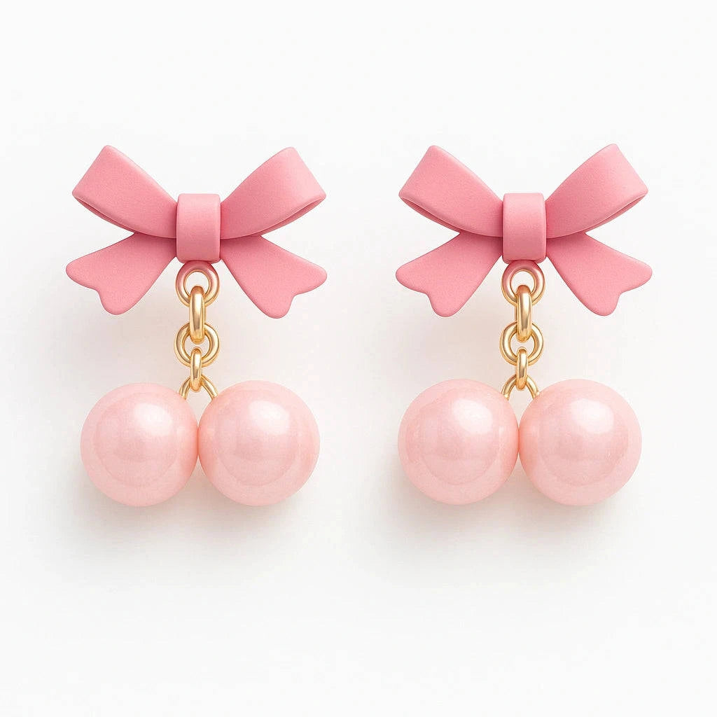 Pair of pink bow earrings with pearl-like beads on a white background