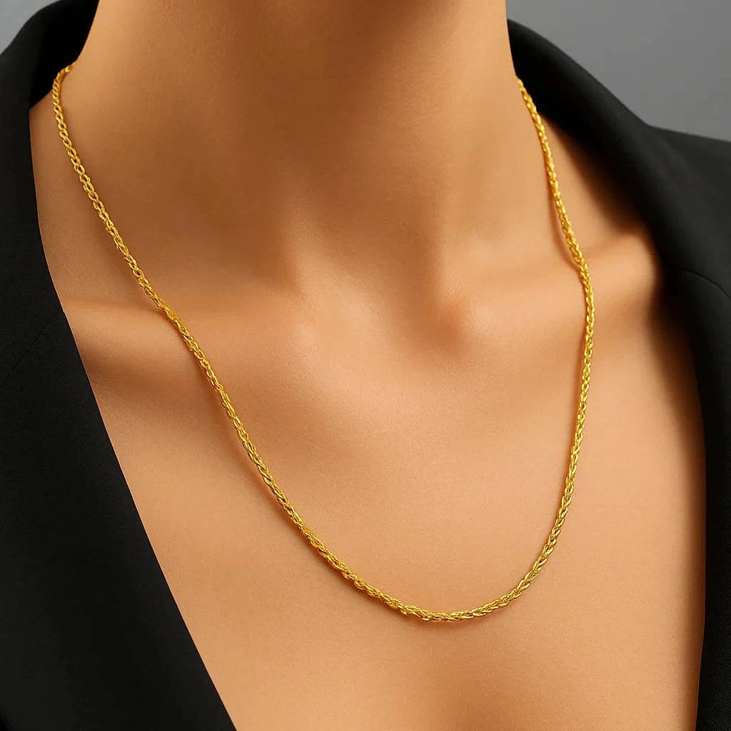 Gold necklace on a mannequin with a black background